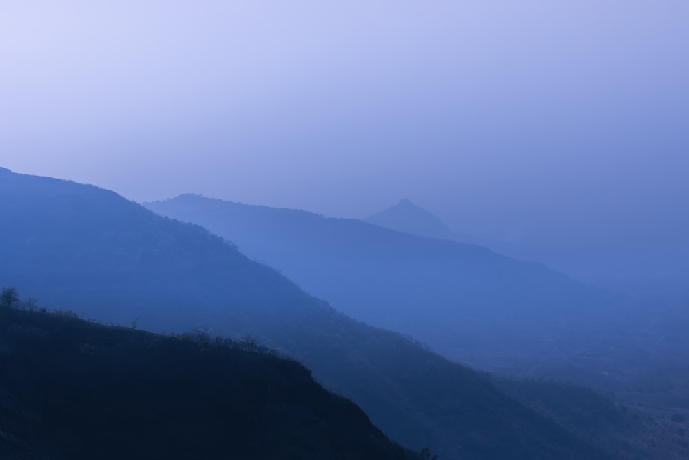 a mountain range with fog