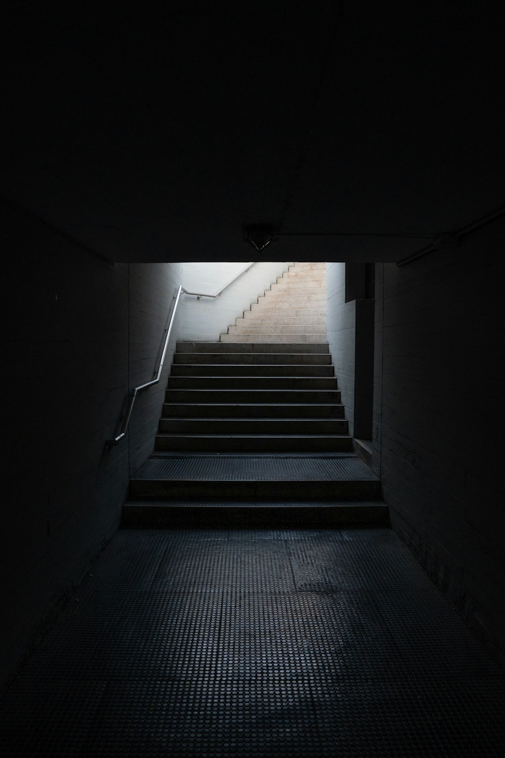 a dark stairwell with light at the top