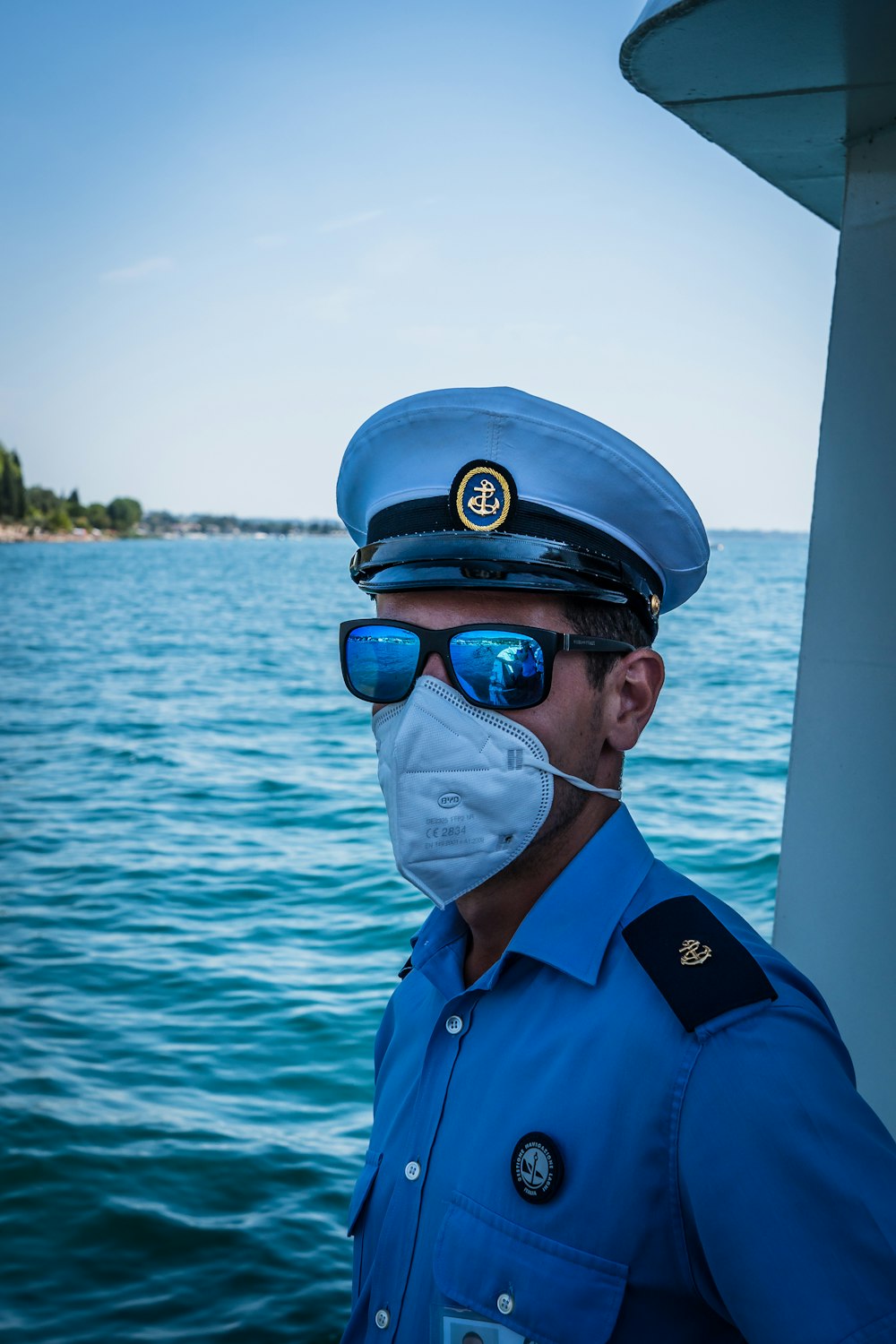 a man wearing a mask and a hat and goggles on a boat