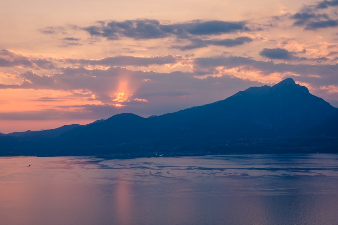 a body of water with mountains in the background,