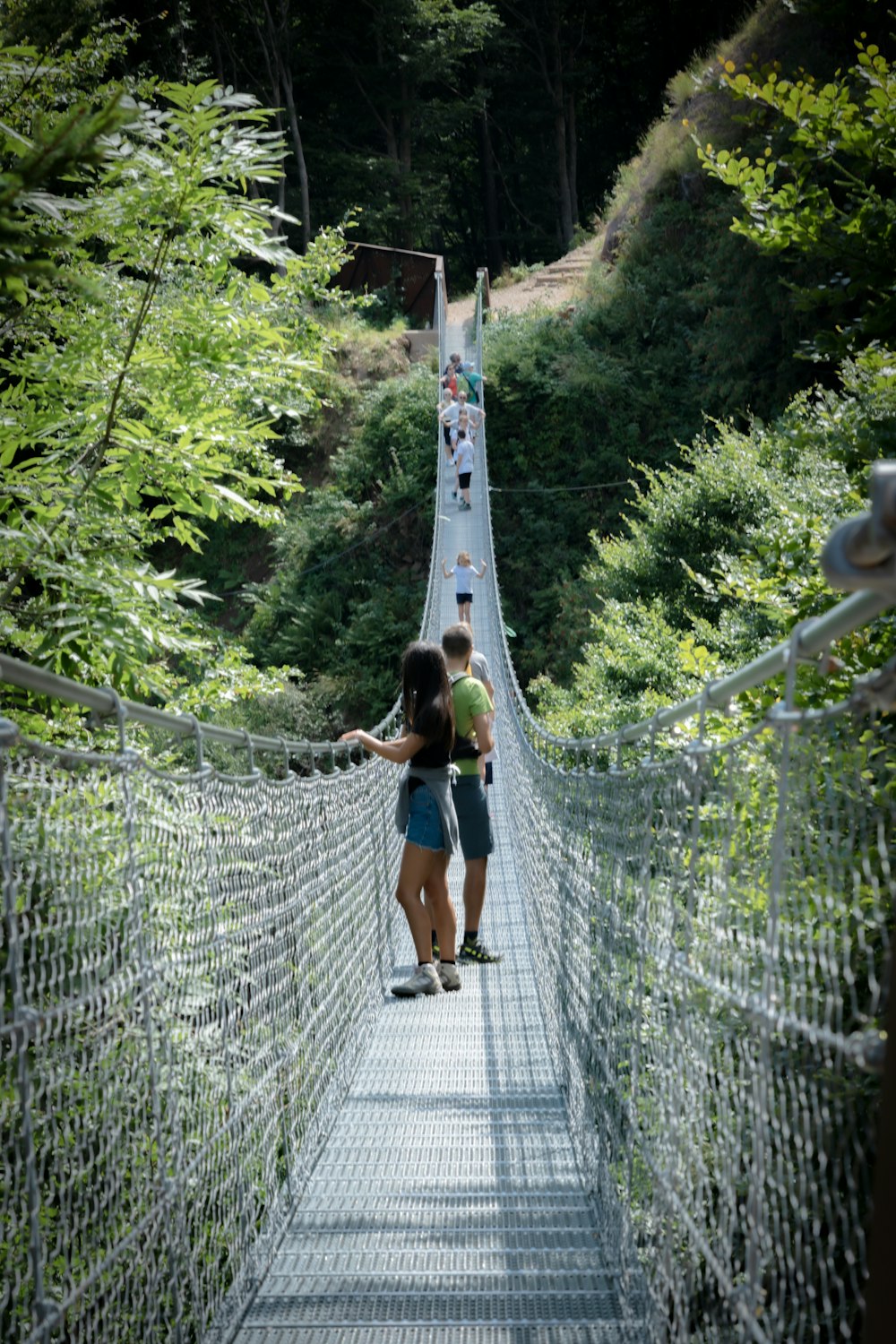 a man and woman on a suspension bridge