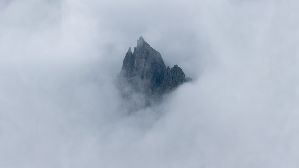 a mountain with clouds around it