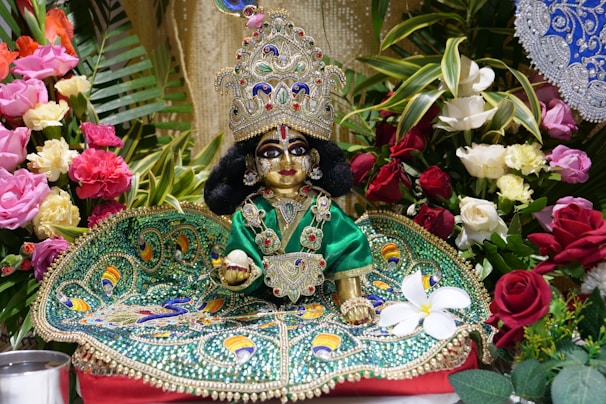 Close-up of a beautiful idol of Lalitha Tripura Sundari surrounded by flowers.