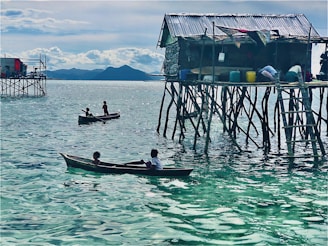 Traditional stilt fishermen silhouetted against the turquoise waters of the southern coast