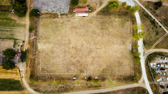 a large field with a building in the background