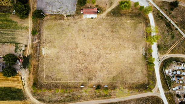 a large field with a building in the background