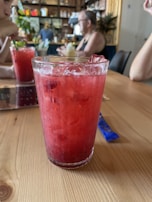 Close-up of ice tubes chilling colorful drinks at a local Semarang café