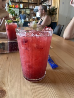 Close-up of a refreshing glass of fresh sugarcane juice on a rustic wooden table