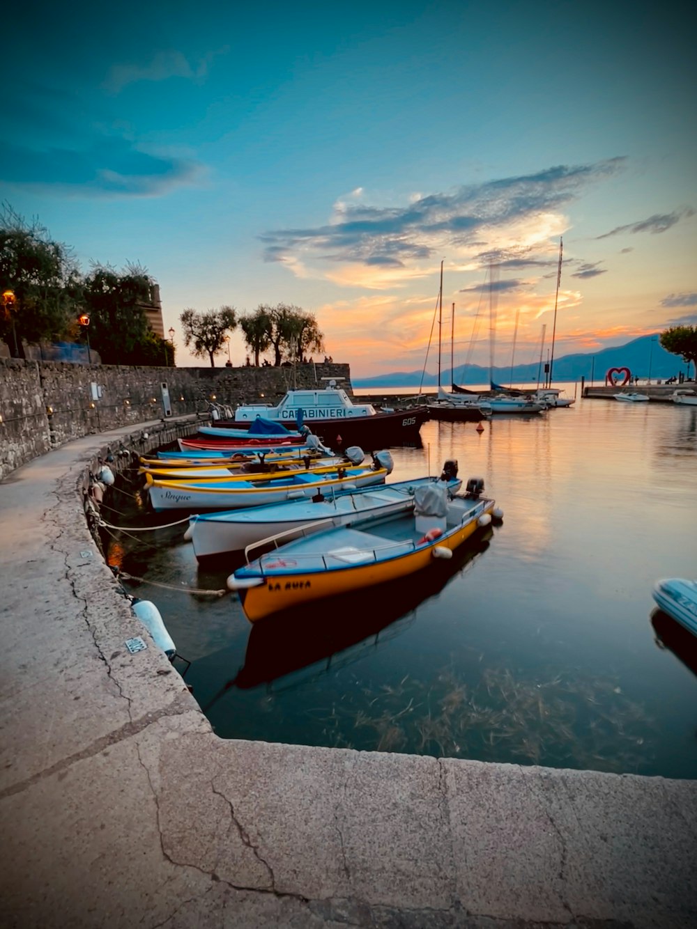 a group of boats sit in a harbor