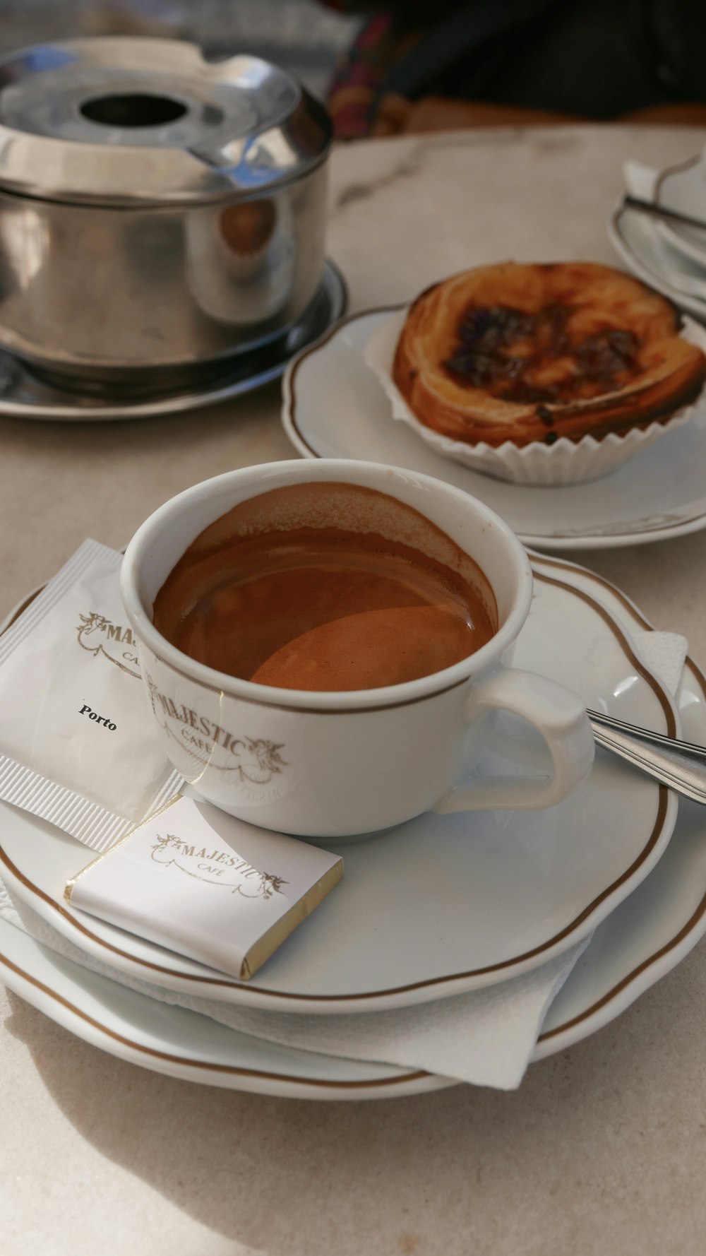 a cup of coffee and a plate of food on a table