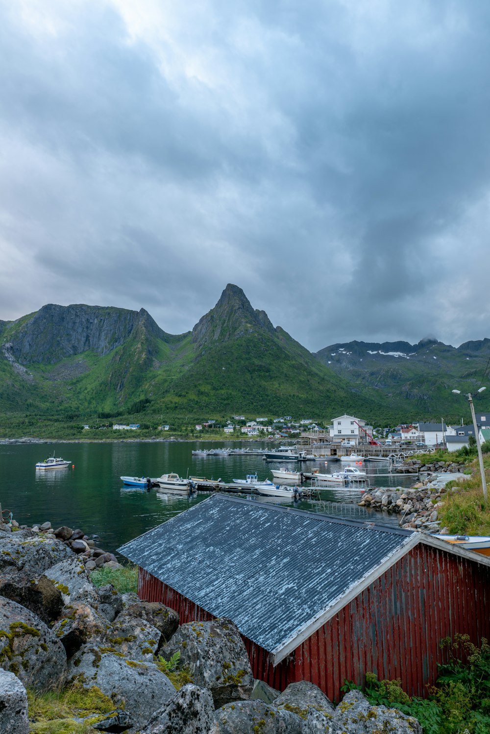 a building next to a body of water with boats in it