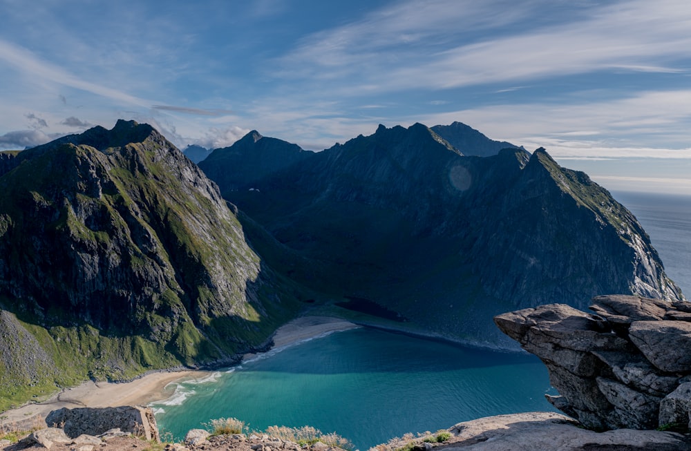 a body of water with mountains in the back