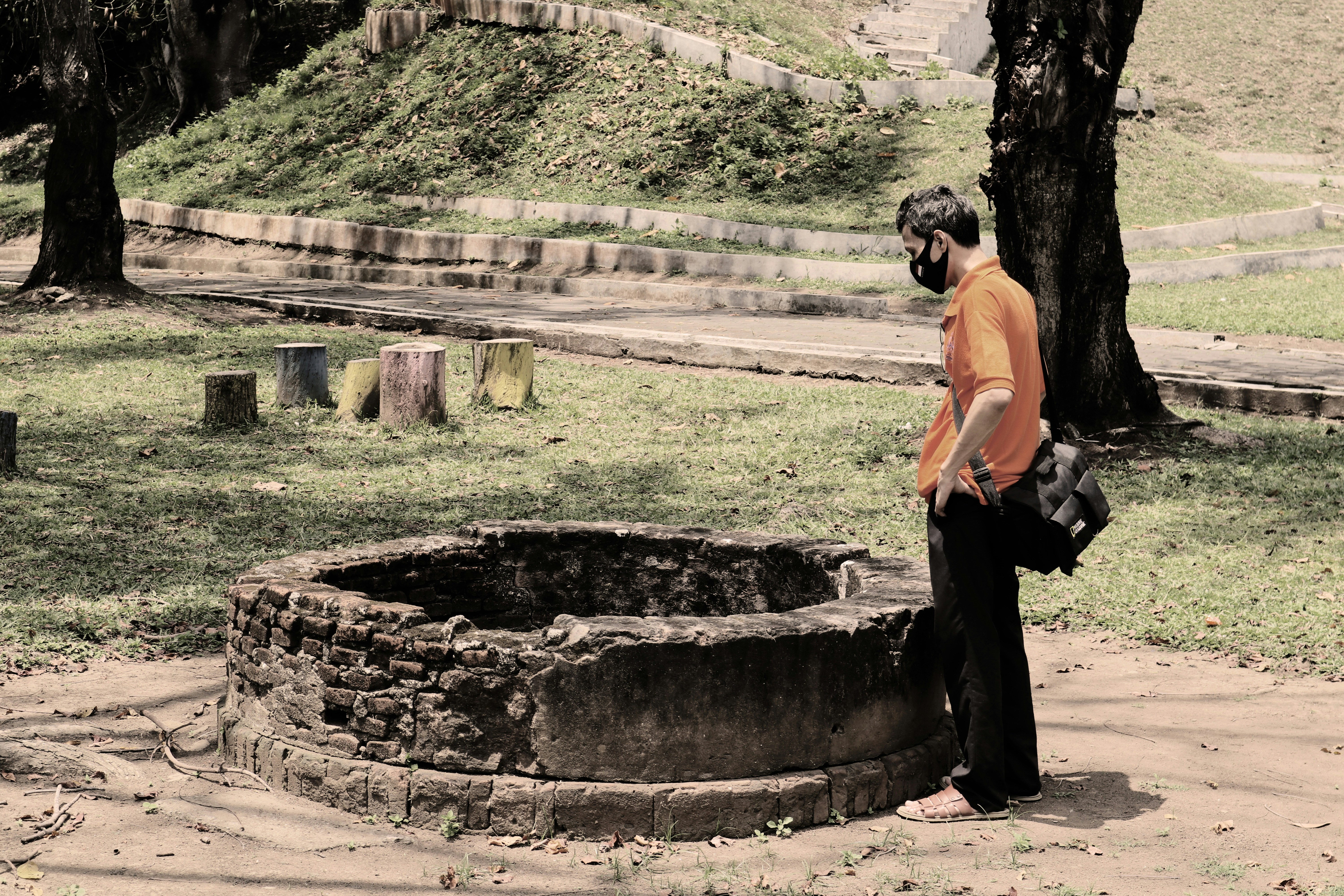 a man standing next to a tree