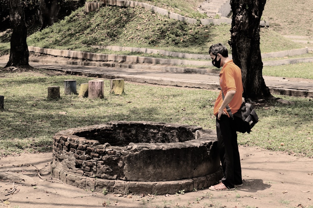 a man standing next to a tree