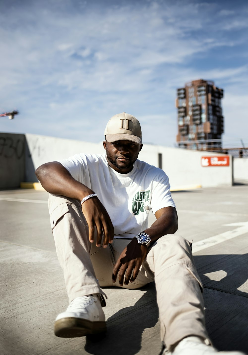 a man sitting on a concrete surface