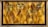 A decorative wall features a geometric patterned background with a warm golden hue. Mounted metal frames hold several small potted plants with lush green foliage, arranged symmetrically. The design blends natural elements with modern art deco style.