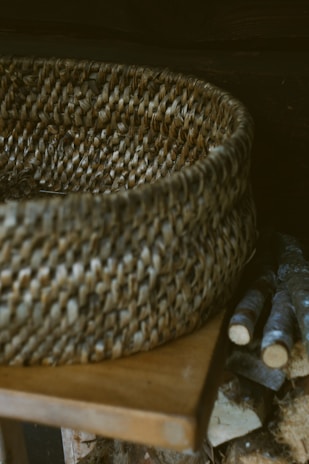 Handmade eco-friendly woven basket sitting on a rustic wooden table.