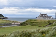 a house on a hill by the water