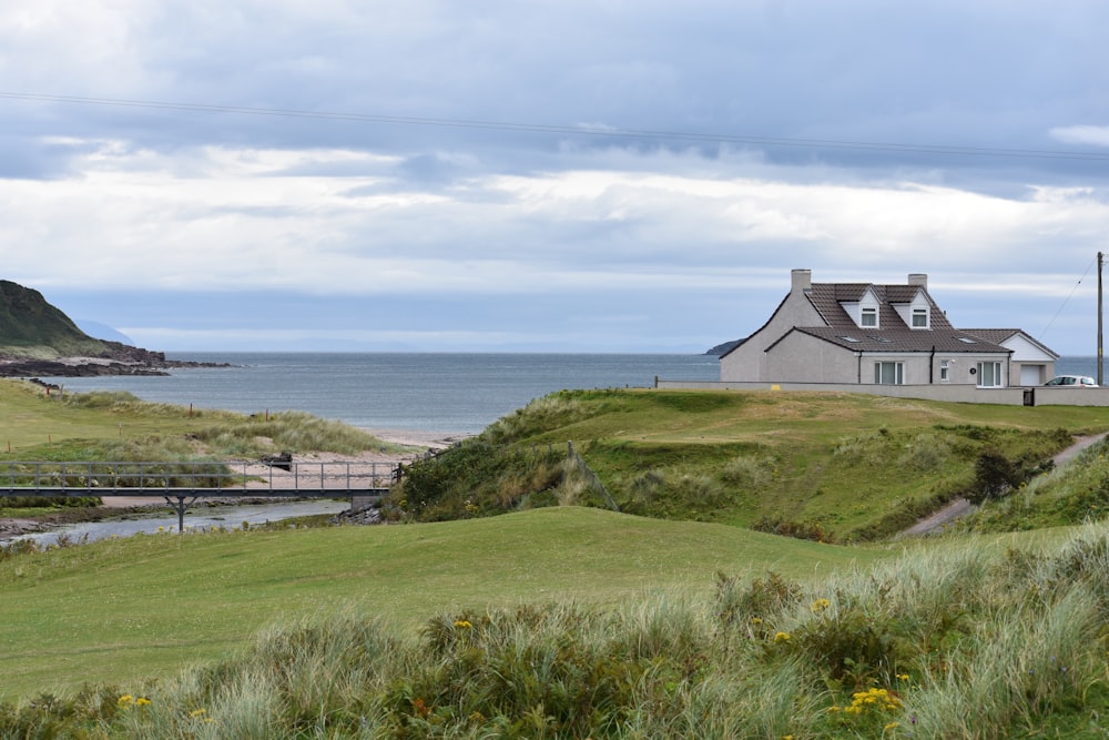 a house on a hill by the water