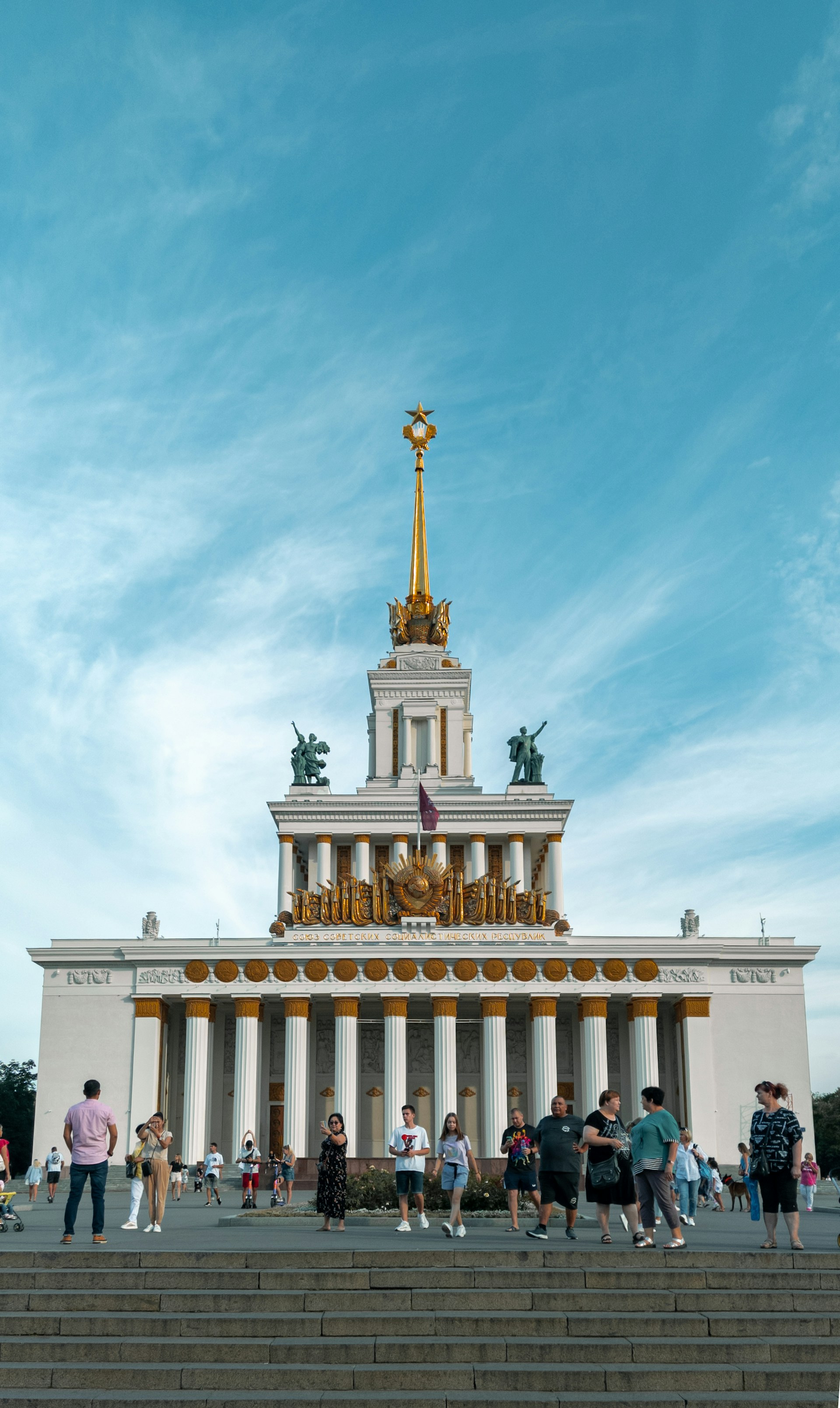 woman wearing yellow long-sleeved dress under white clouds and blue sky during daytime