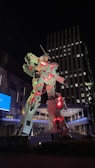 Robot LED performer glowing with vibrant lights in a nighttime festival setting.