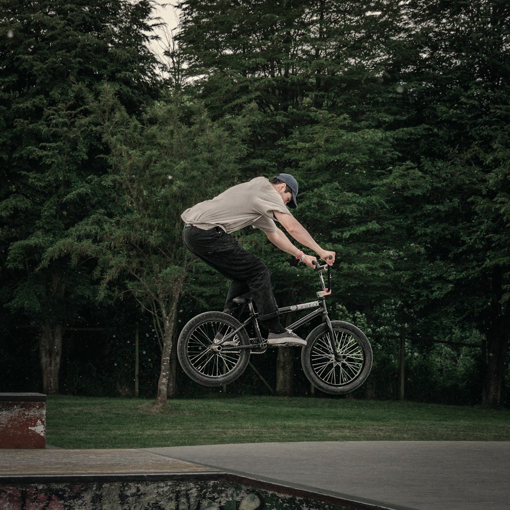 a man doing a trick on a bicycle