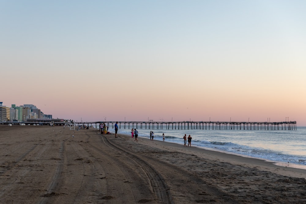 a group of people walking on a beach