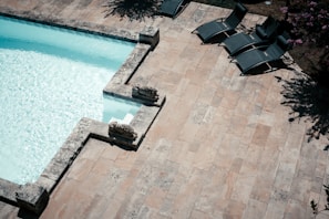 a pool with chairs around it