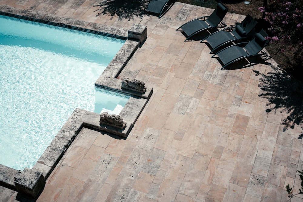 a pool with chairs around it