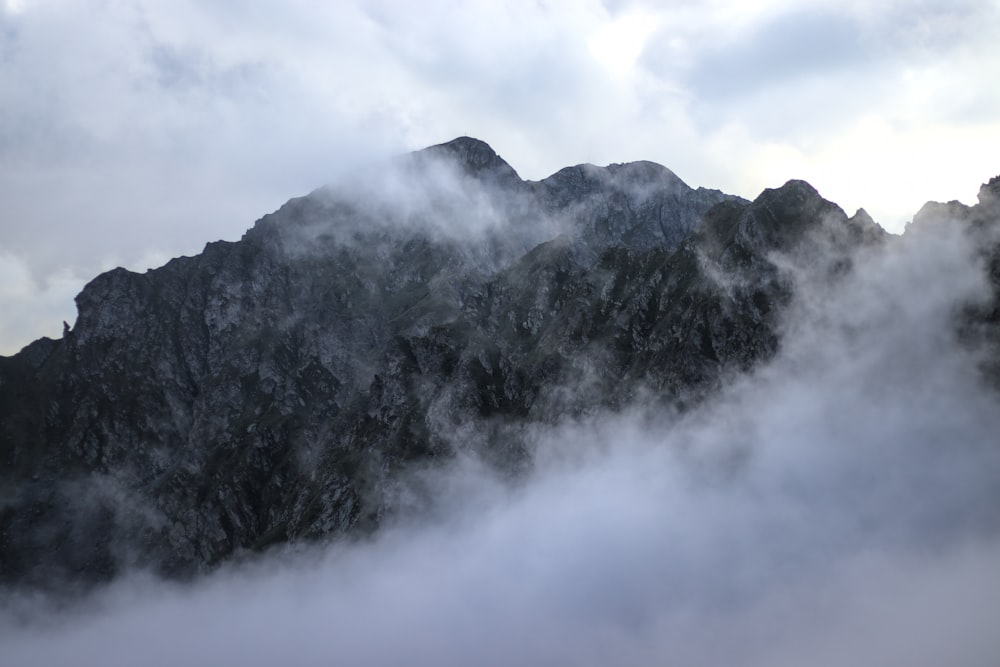 a mountain with clouds around it