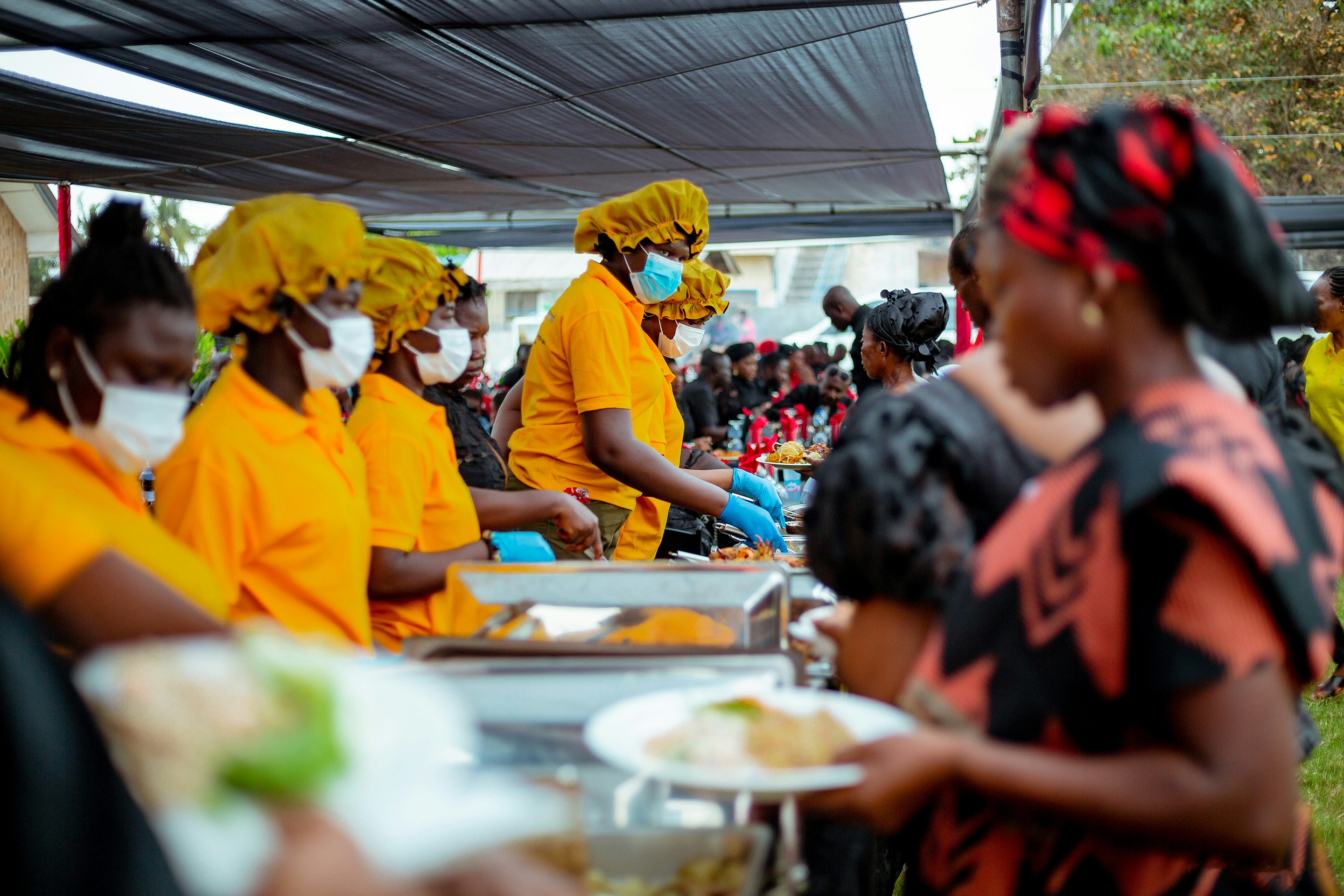 a group of people wearing masks, We eat together as one