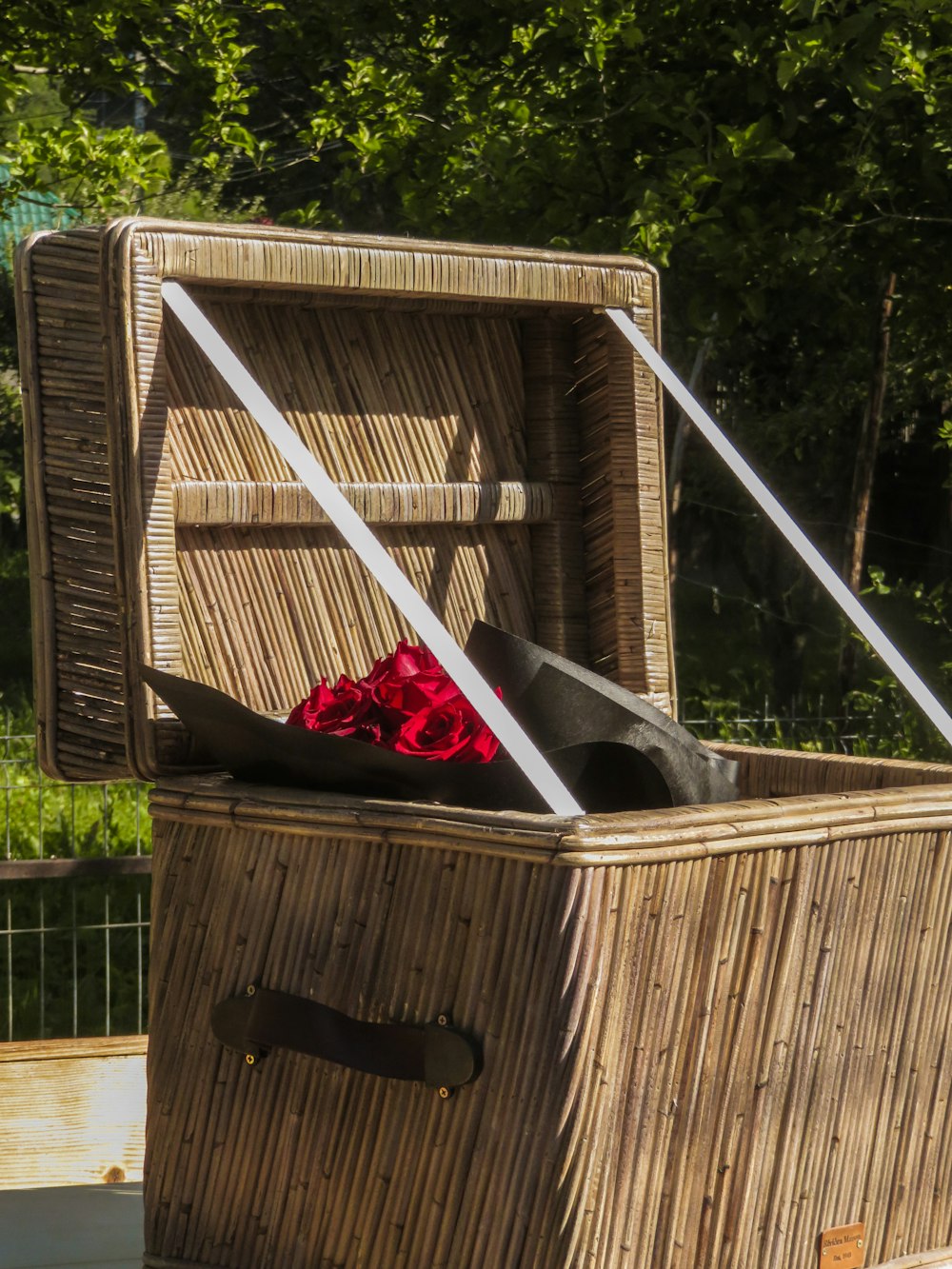 a wooden birdhouse with a red bow and a black bird on it