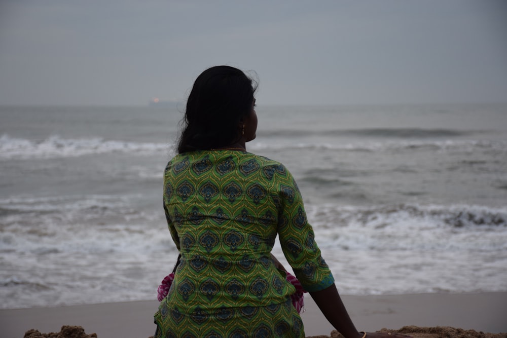 a man standing on a beach looking at the ocean