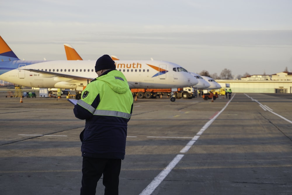 a person standing in front of an airplane