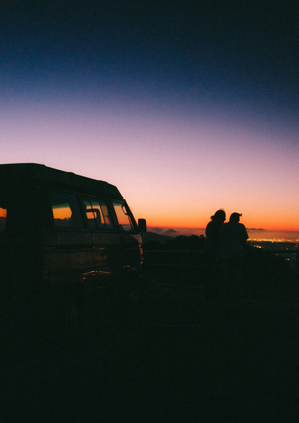 a truck parked in front of a sunset