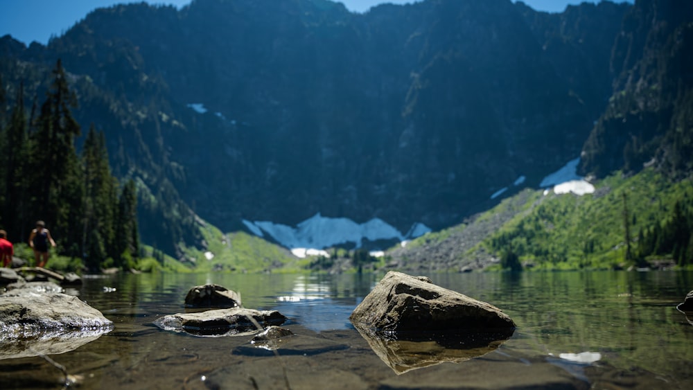 a lake with mountains in the background