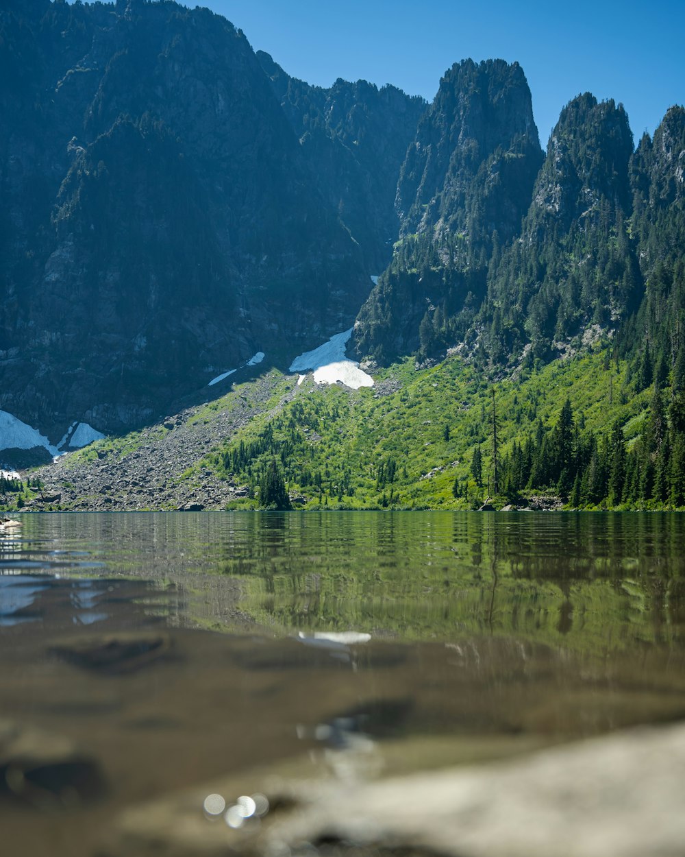 a lake with mountains in the background