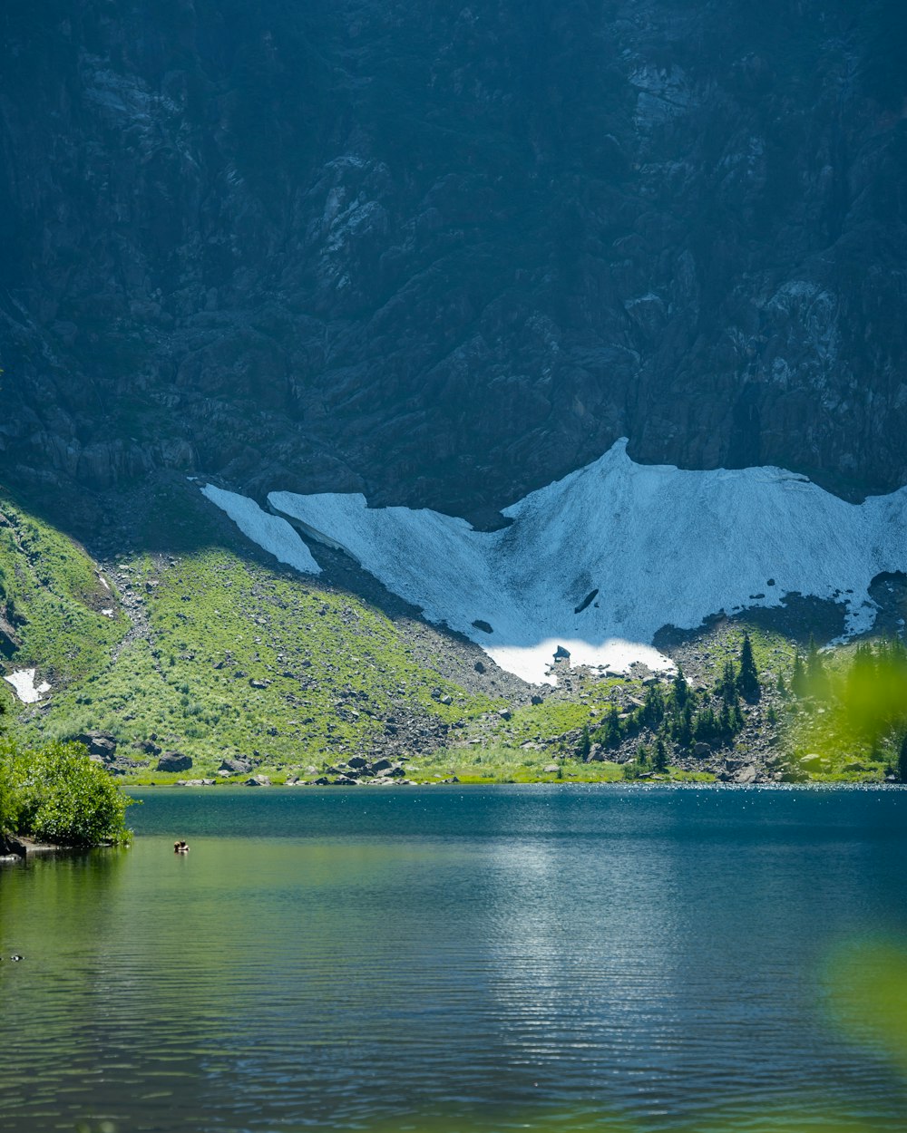 a body of water with mountains in the back