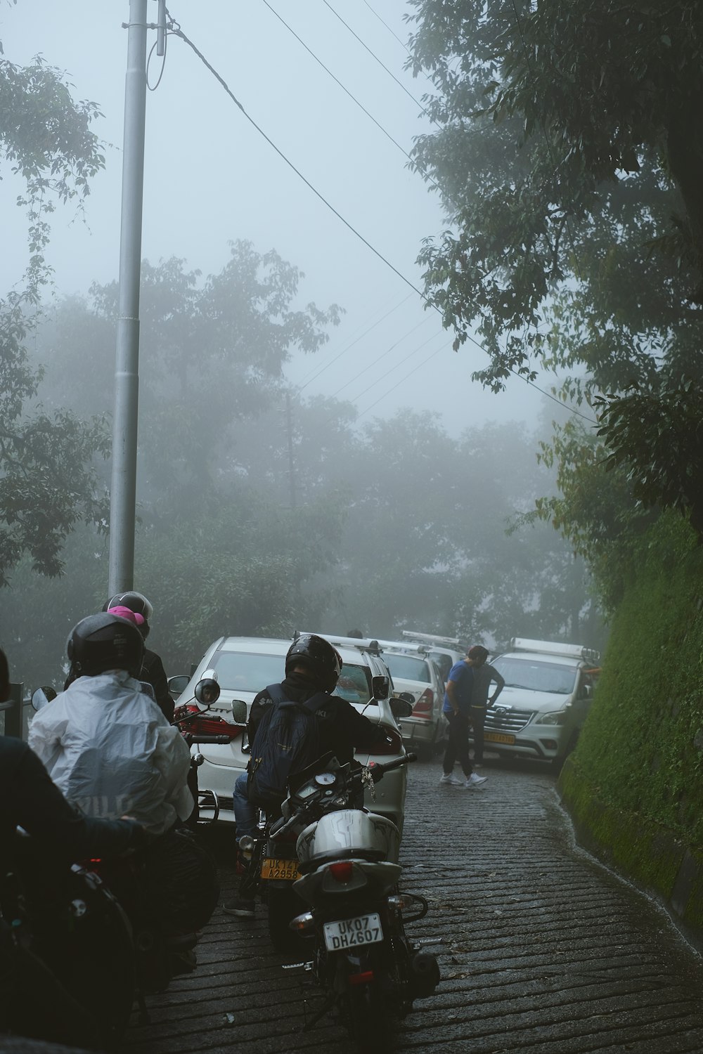 a group of people ride on a motorcycle down a street