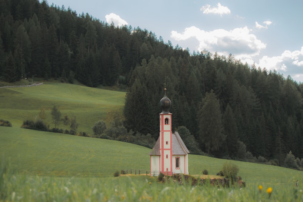 a small church in a grassy field
