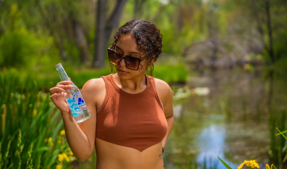 a woman holding a water bottle