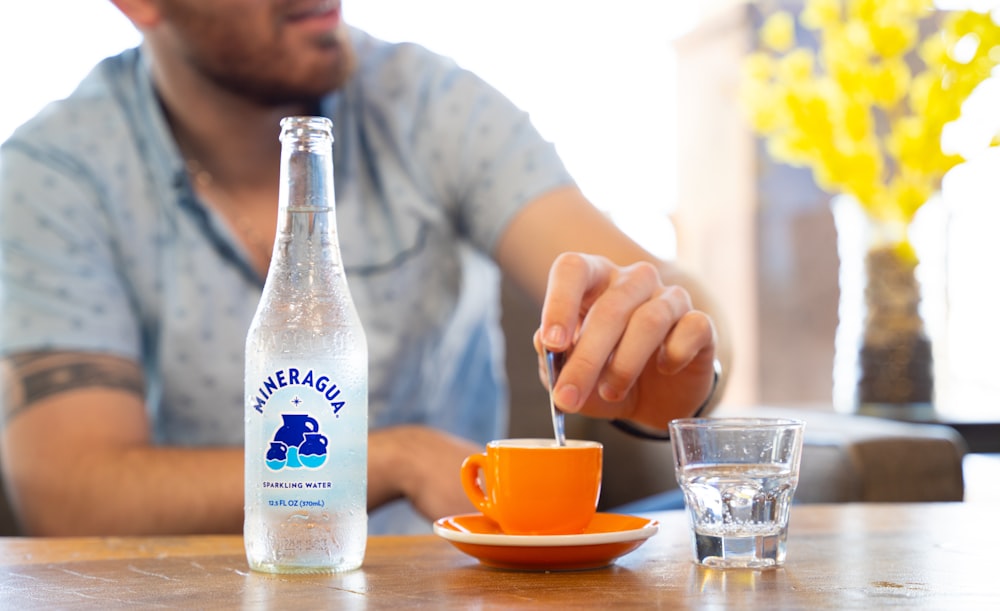 a person pouring a liquid into a bottle