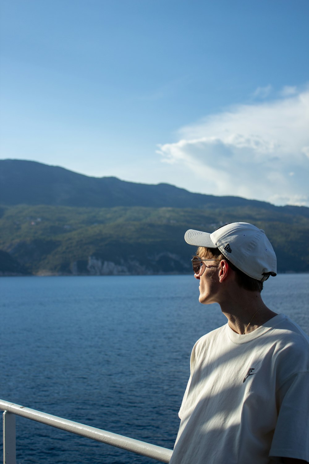 a man standing on a boat looking out at the water