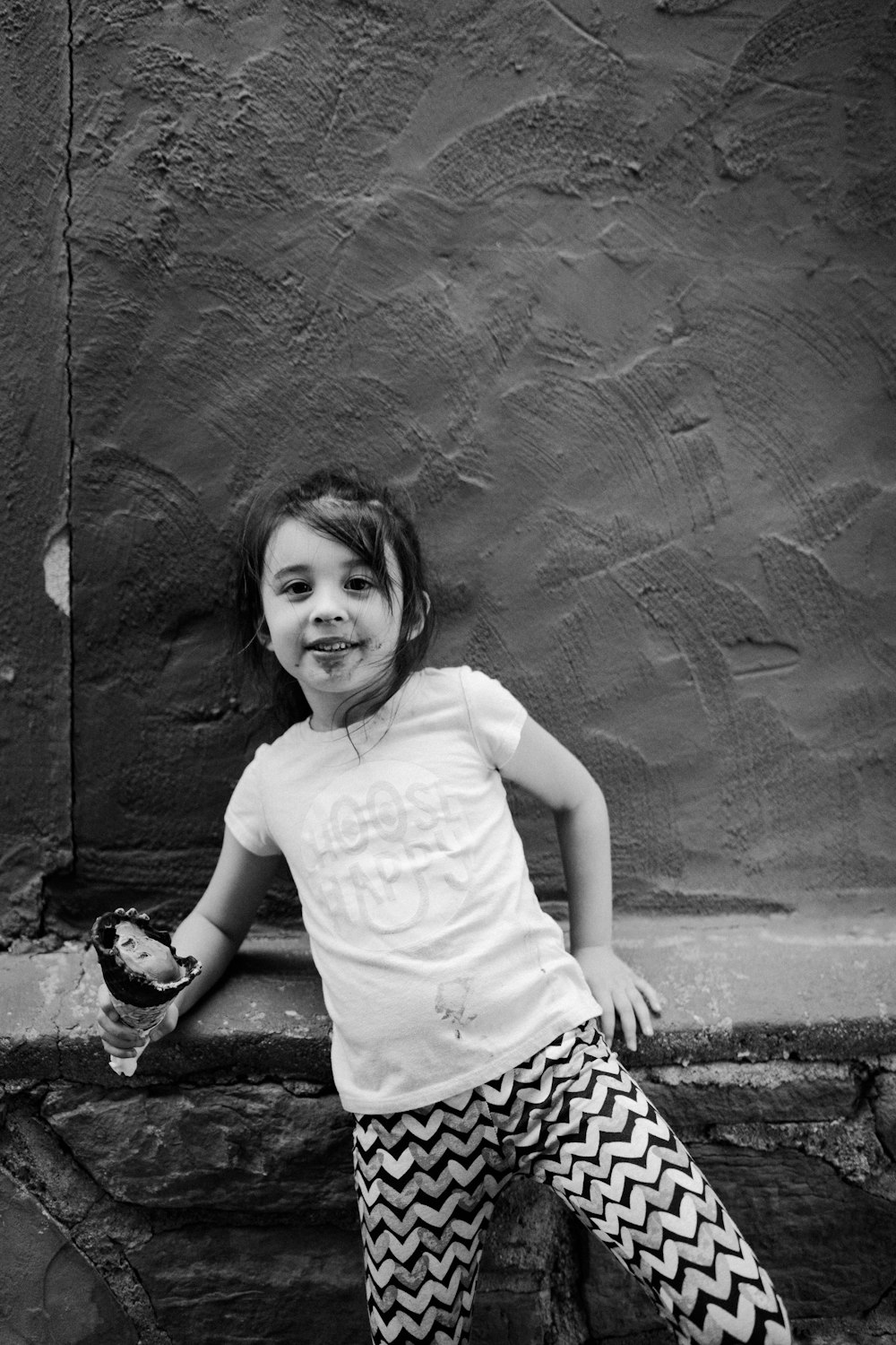 a girl sitting on a ledge