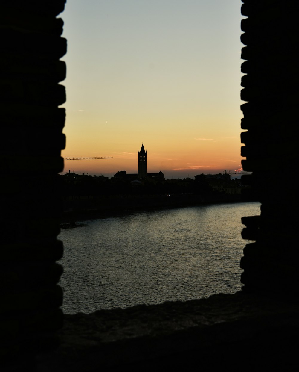 a body of water with a tower in the distance