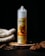 A bottle labeled 'Euro Tobacco Almond 3MG 70/30' with an illustration of almonds and tobacco leaves. It stands on a textured wooden surface surrounded by natural materials like rope, wood chips, and fibers against a dark background.