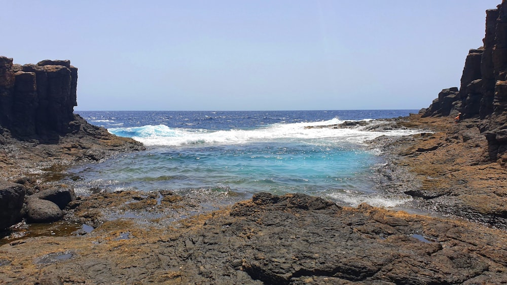 a rocky beach with waves crashing