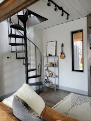 a room with a staircase and a bookcase