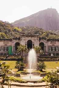a large building with a fountain in front of it