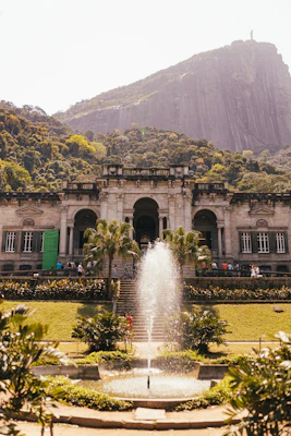a large building with a fountain in front of it
